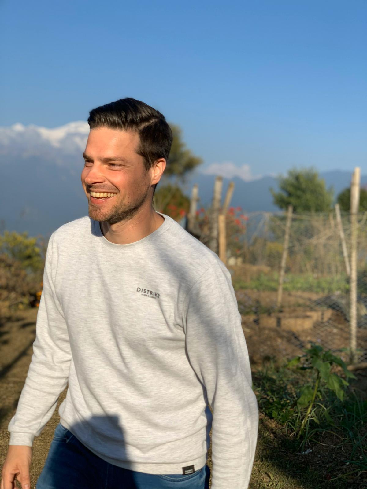 Robbert, founder of The Centered Founder, standing outdoors in the mountains at sunrise